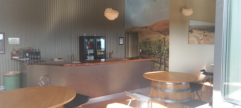 Wide view of the cellar door interior with tables and the bar