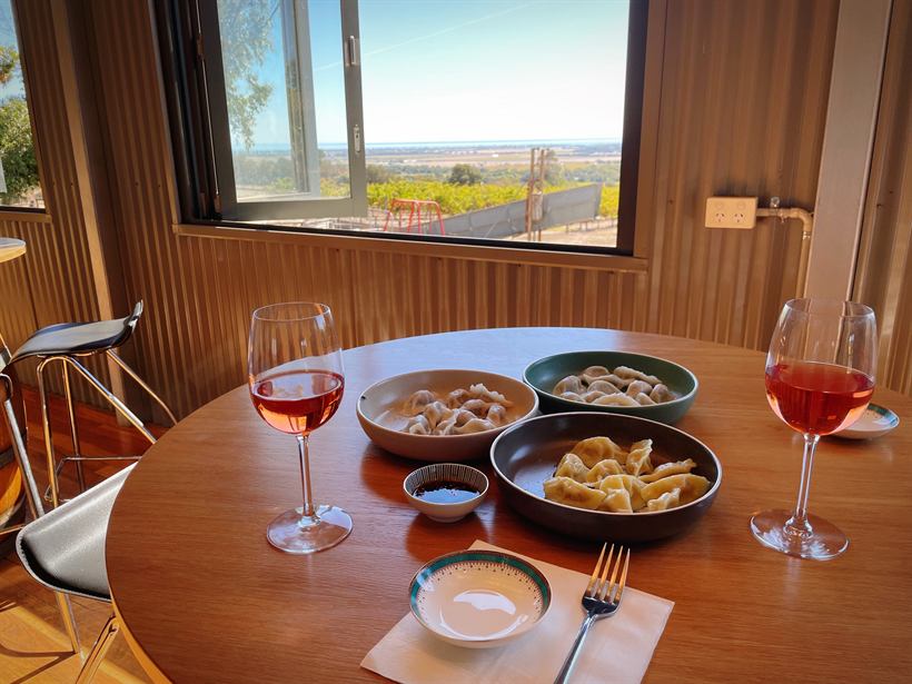 Rosé and dumplings on a round table beside the window